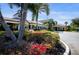 Beautiful clubhouse exterior with palm trees and manicured landscaping on a bright, sunny day at 221 Shell Falls Dr, Apollo Beach, FL 33572