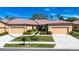 Charming single-story home with well-manicured lawn, mature landscaping and a tile roof at 221 Shell Falls Dr, Apollo Beach, FL 33572