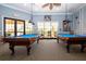 Bright game room with two beautiful blue felt pool tables, comfortable seating and good light at 221 Shell Falls Dr, Apollo Beach, FL 33572