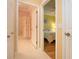 Hallway view showcasing entrances to a bedroom and bathroom, highlighting the home's layout at 221 Shell Falls Dr, Apollo Beach, FL 33572