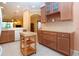 Open kitchen with light cabinets, an island, and tiled flooring at 221 Shell Falls Dr, Apollo Beach, FL 33572