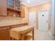 Eat-in kitchen with wooden cabinets and drawers, butcher block island and white doors at 221 Shell Falls Dr, Apollo Beach, FL 33572