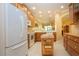 Bright kitchen features wooden cabinets, white appliances, and a butcher block island on tile flooring at 221 Shell Falls Dr, Apollo Beach, FL 33572