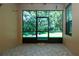 Enclosed lanai with tiled flooring and a serene view of lush greenery at 221 Shell Falls Dr, Apollo Beach, FL 33572