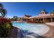 Bright outdoor community pool with lounge chairs and clubhouse in the background at 221 Shell Falls Dr, Apollo Beach, FL 33572
