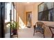 Inviting front porch features neutral walls, tiled floor, and wicker chair at 221 Shell Falls Dr, Apollo Beach, FL 33572
