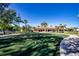 Putting green with a golf club and ball, near the clubhouse and palm trees at 221 Shell Falls Dr, Apollo Beach, FL 33572