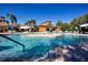 Community pool featuring a central island, lounge seating, and tropical landscaping at 221 Shell Falls Dr, Apollo Beach, FL 33572