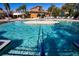 Outdoor swimming pool with seating area, palm trees, and beautiful landscaping at 221 Shell Falls Dr, Apollo Beach, FL 33572
