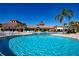 Large outdoor swimming pool with lounge chairs and beautiful view of community buildings at 221 Shell Falls Dr, Apollo Beach, FL 33572