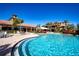 Beautiful outdoor pool with brick trim and lounge seating overlooking community buildings at 221 Shell Falls Dr, Apollo Beach, FL 33572