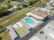 Aerial view showcasing the community pool and shuffleboard courts at 250 Nw Rosery Rd # 314, Largo, FL 33770