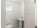 Powder room includes a pedestal sink and toilet at 250 Nw Rosery Rd # 314, Largo, FL 33770