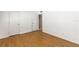 This bedroom features wood-look floors, white trim and white walls at 250 Nw Rosery Rd # 314, Largo, FL 33770