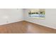 Cozy bedroom featuring hardwood flooring and a large window at 250 Nw Rosery Rd # 314, Largo, FL 33770
