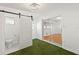 Bedroom with green carpet, modern light fixture, and sliding glass door at 250 Nw Rosery Rd # 314, Largo, FL 33770