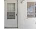 Welcoming front entrance featuring a white door and window at 250 Nw Rosery Rd # 314, Largo, FL 33770
