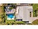 An aerial view of a house with a large gray roof and outdoor pool with nearby green vegetation at 2674 Fairway S Ave, St Petersburg, FL 33712