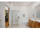 Bright bathroom featuring a glass-enclosed shower, soaking tub, and walk-in closet at 31815 Blythewood Way, Wesley Chapel, FL 33543