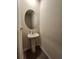 Powder room featuring pedestal sink and a round mirror at 3267 Pleasant Willow Ct, Brandon, FL 33511