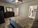 Spacious bedroom featuring a large bed, dresser with mirror, and entry to ensuite bathroom at 3267 Pleasant Willow Ct, Brandon, FL 33511