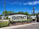 Eye-level shot of The District community sign on a sunny day, with well-maintained landscaping at 3267 Pleasant Willow Ct, Brandon, FL 33511