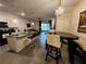 Open concept kitchen features a granite island with barstools, transitioning into the dining and living areas at 3267 Pleasant Willow Ct, Brandon, FL 33511