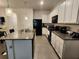 Stylish kitchen featuring granite countertops, modern appliances, white cabinets and a functional island at 3267 Pleasant Willow Ct, Brandon, FL 33511