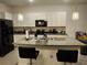 Bright kitchen showcasing a large island, granite countertops, modern lighting and stainless steel appliances at 3267 Pleasant Willow Ct, Brandon, FL 33511