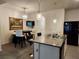 The kitchen island has a granite countertop and bar seating, next to the dining area for casual meals at 3267 Pleasant Willow Ct, Brandon, FL 33511