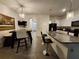 This kitchen has a granite countertop island and bar seating, and opens into the dining area at 3267 Pleasant Willow Ct, Brandon, FL 33511