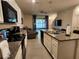 Modern kitchen with stainless steel appliances, granite countertops, and a seamless flow to the living area at 3267 Pleasant Willow Ct, Brandon, FL 33511