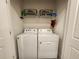 Laundry room with washer, dryer, shelving and laundry supplies at 3267 Pleasant Willow Ct, Brandon, FL 33511