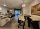 Open-concept living area featuring a dining table, bar seating and access to outdoor space at 3267 Pleasant Willow Ct, Brandon, FL 33511