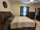 Bedroom with a dark wood frame bed, ceiling fan, and matching furniture at 3267 Pleasant Willow Ct, Brandon, FL 33511