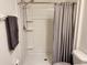 Bathroom shower stall with shower head, shelves and gray curtain at 3267 Pleasant Willow Ct, Brandon, FL 33511