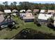 Aerial view showcasing backyard of a home with a pool, lush greenery, and a serene pond setting at 3639 Darston St, Palm Harbor, FL 34685