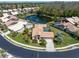Aerial view of a home with a pool, nestled in a community with a pond and lush landscaping at 3639 Darston St, Palm Harbor, FL 34685