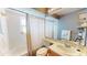 Bright bathroom features a shower-tub combo with white tile and a vanity with a mirror at 3639 Darston St, Palm Harbor, FL 34685