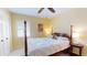 Bedroom with yellow walls, ceiling fan, and a four poster bed at 3639 Darston St, Palm Harbor, FL 34685