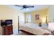 Bedroom with yellow walls, ceiling fan, and a four poster bed at 3639 Darston St, Palm Harbor, FL 34685