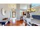 Inviting entryway and dining area featuring a modern chandelier and hardwood floors at 3639 Darston St, Palm Harbor, FL 34685