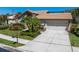 Charming home with a well-manicured lawn, lush landscaping, and a two-car garage at 3639 Darston St, Palm Harbor, FL 34685