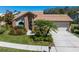 Well-maintained home featuring lush landscaping and a charming front entrance at 3639 Darston St, Palm Harbor, FL 34685