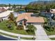 Beautiful home with mature landscaping, tile roof, and pond view at 3639 Darston St, Palm Harbor, FL 34685