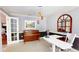 Home office featuring an adjustable desk, piano, and modern lighting at 3639 Darston St, Palm Harbor, FL 34685