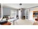 Home office featuring an adjustable desk, modern lighting, and views of the kitchen at 3639 Darston St, Palm Harbor, FL 34685