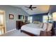 A light filled main bedroom with blue walls and a ceiling fan at 3639 Darston St, Palm Harbor, FL 34685