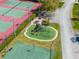 An aerial view of a playground featuring slides and other play equipment next to a basketball and tennis court at 3639 Darston St, Palm Harbor, FL 34685