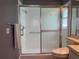 Updated bathroom with a modern glass-enclosed shower and white tile at 3639 Darston St, Palm Harbor, FL 34685